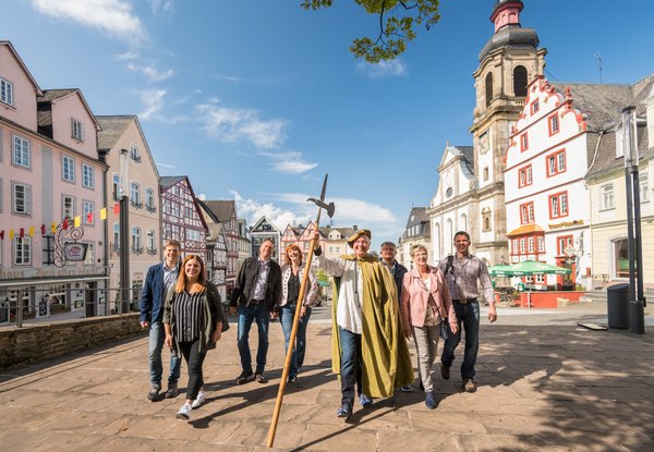 Gruppe von Personen mit historischem Gewand in städtischer Umgebung